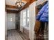 Stylish entryway with a brick accent wall, wooden beams, and tile flooring at 303 Island Ford Rd, Maiden, NC 28650