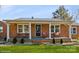 Charming single-story brick home with a cozy front porch and well-manicured landscaping at 303 Island Ford Rd, Maiden, NC 28650