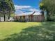 Charming single-story home with a well-maintained lawn, mature trees, and metal roof at 303 Island Ford Rd, Maiden, NC 28650