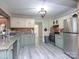 Charming kitchen with modern appliances, granite counters, and wood backsplash on newer laminate floors at 303 Island Ford Rd, Maiden, NC 28650