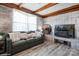 Cozy living room with a brick accent wall, comfortable seating, and natural light at 303 Island Ford Rd, Maiden, NC 28650