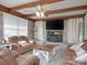 Inviting living room with exposed beams, brick fireplace, plush seating and stylish decor at 303 Island Ford Rd, Maiden, NC 28650