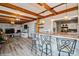 Bright living room with wooden beams, brick fireplace, bar seating and hardwood floors at 303 Island Ford Rd, Maiden, NC 28650