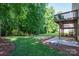 Expansive backyard featuring a deck, lush green lawn, and mature trees at 319 Beacon Hills Dr, Gastonia, NC 28056