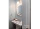 Bathroom with a pedestal sink, a large mirror, and a wall-mounted light at 319 Beacon Hills Dr, Gastonia, NC 28056
