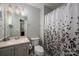 Bathroom featuring a floral shower curtain, brushed light fixture, and neutral walls at 319 Beacon Hills Dr, Gastonia, NC 28056