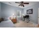 Bedroom with blue walls and carpet, a twin bed, a ceiling fan, and a desk with computer at 319 Beacon Hills Dr, Gastonia, NC 28056