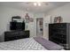 A well decorated bedroom with dark wood furniture, and access to laundry area at 319 Beacon Hills Dr, Gastonia, NC 28056