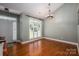 Sunlit dining area with hardwood floors, neutral walls and a large window with backyard views at 319 Beacon Hills Dr, Gastonia, NC 28056
