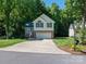 Inviting two-story house with a blend of brick and siding, featuring a two-car garage and pristine front lawn at 319 Beacon Hills Dr, Gastonia, NC 28056