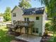 Back exterior view with deck, patio, and well manicured lawn at 319 Beacon Hills Dr, Gastonia, NC 28056
