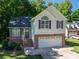 Charming two-story home features a brick and siding exterior, attached garage, and well-maintained lawn at 319 Beacon Hills Dr, Gastonia, NC 28056