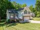 Beautiful two-story house has an attached garage, brick and siding accents, and a lush green lawn at 319 Beacon Hills Dr, Gastonia, NC 28056