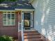 Close-up of the brick-lined entryway, featuring a black front door, white railings, and a welcoming entrance at 319 Beacon Hills Dr, Gastonia, NC 28056