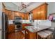 Well-equipped kitchen with granite countertops, stainless steel appliances, oak cabinets and hardwood floors at 319 Beacon Hills Dr, Gastonia, NC 28056