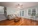 Living room with comfortable seating, hardwood floors, and large windows at 319 Beacon Hills Dr, Gastonia, NC 28056