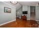 Spacious living area with hardwood floors, neutral walls, staircase and a large television at 319 Beacon Hills Dr, Gastonia, NC 28056