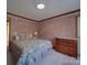 Bedroom with a floral wallpaper, matching bedding, and wood furniture at 3750 Turner Rd, Clover, SC 29710