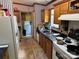 Well-equipped kitchen with a white refrigerator, wooden cabinets, and ample countertop space at 3750 Turner Rd, Clover, SC 29710