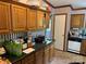 Traditional kitchen with oak cabinetry, laminate countertops and black appliances at 3750 Turner Rd, Clover, SC 29710