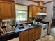 Functional kitchen with oak cabinetry, stainless steel sink and white appliances at 3750 Turner Rd, Clover, SC 29710