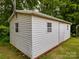 Angled shot of a white outbuilding with a single door and multiple small windows on a well-manicured lawn at 3750 Turner Rd, Clover, SC 29710