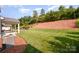 Spacious backyard featuring a lush green lawn, mature trees, and well-maintained landscaping at 4324 Falls Lake Sw Dr, Concord, NC 28025