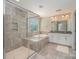 Modern bathroom with a tiled shower, soaking tub, and double vanity at 4324 Falls Lake Sw Dr, Concord, NC 28025