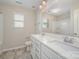 Bright bathroom with a dual sink vanity and a shower/tub combo at 4324 Falls Lake Sw Dr, Concord, NC 28025