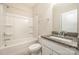 Bathroom featuring a granite-topped vanity and shower-tub combination at 4324 Falls Lake Sw Dr, Concord, NC 28025