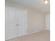 A bedroom showcasing neutral walls, carpet, and a closet with double doors, offering storage space at 4324 Falls Lake Sw Dr, Concord, NC 28025