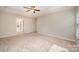 Spacious bedroom featuring a ceiling fan, tray ceiling, and neutral tones at 4324 Falls Lake Sw Dr, Concord, NC 28025