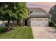 Charming two-story home featuring a well-manicured lawn, attached garage, and beautiful stone accents at 4324 Falls Lake Sw Dr, Concord, NC 28025