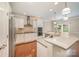 Modern kitchen with white cabinets, stainless steel appliances, an eat-in area and hardwood floors at 4324 Falls Lake Sw Dr, Concord, NC 28025