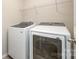 Modern laundry room with white Samsung washer and dryer, and a wire shelf for added storage at 4324 Falls Lake Sw Dr, Concord, NC 28025