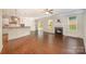 Open-concept living room featuring wood floors, a fireplace, and a smooth transition into the kitchen at 4324 Falls Lake Sw Dr, Concord, NC 28025