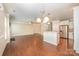 Open-concept living space featuring a dining area, kitchen, and living room with hardwood floors at 4324 Falls Lake Sw Dr, Concord, NC 28025