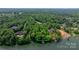 Stunning aerial view of a waterfront property surrounded by lush greenery, showcasing its private dock and serene lakeside setting at 4647 16Th Street Ne Pl, Hickory, NC 28601