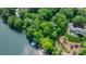 Beautiful aerial view of a lakeside home surrounded by mature trees, landscaping, and a private dock at 4647 16Th Street Ne Pl, Hickory, NC 28601