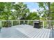 Spacious back deck featuring a grill, potted plants, and scenic tree views at 4647 16Th Street Ne Pl, Hickory, NC 28601