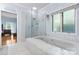Bright bathroom features a soaking tub, glass shower, and tiled flooring at 4647 16Th Street Ne Pl, Hickory, NC 28601