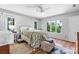 Well-lit bedroom featuring hardwood floors, multiple windows, and white accents at 4647 16Th Street Ne Pl, Hickory, NC 28601