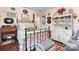 Charming bedroom features a black metal bed frame, floral bedding, and a decorative hutch at 4647 16Th Street Ne Pl, Hickory, NC 28601