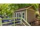 Exterior of a cozy brown building on a wooden deck surrounded by lush greenery at 4647 16Th Street Ne Pl, Hickory, NC 28601