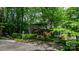 Exterior view of home surrounded by lush, mature trees and landscaping at 4647 16Th Street Ne Pl, Hickory, NC 28601