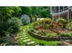 Backyard landscaping featuring a stone pathway, vibrant flower beds, and a storage shed at 4647 16Th Street Ne Pl, Hickory, NC 28601