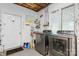 Laundry room featuring modern washer and dryer units plus storage shelves at 4647 16Th Street Ne Pl, Hickory, NC 28601