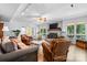 Open living room showcasing a fireplace, ceiling fan, and outside views at 4647 16Th Street Ne Pl, Hickory, NC 28601