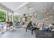 Spacious screened-in porch features brick walls, a ceiling fan, and comfortable seating with a beautiful view at 4647 16Th Street Ne Pl, Hickory, NC 28601