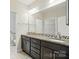Bathroom featuring double sink vanity, granite countertops, and large mirror at 5028 Polo Gate Blvd, Charlotte, NC 28216